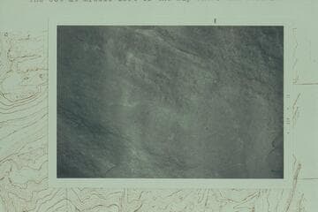 John F. Hoffman's effort to photograph a D. Julien inscription on the east side of a boulder at Mile 212 1/2, left bank, 1/4 mile from the river and 600 ft. above it.  Discovery is credited to Mark Lindquist of Portland