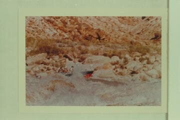 The "Bootoo" in Badger Creek Rapid. Left to right: Buzz Belknap, Dock Marston and Vee Bodrero